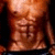 A muscular male torso with defined abs and a cross tattoo, wearing dark pants held up by hands at the waist.