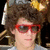 four green with blue text labels and a pixelated photo of a person with curly hair and red sunglasses in the top-left