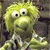 A pixelated contact sheet showing two frames of an animated icon featuring a yellow puppet character on the left and green text reading "Original Icons .com" on the right against a dark background.