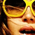 A person wearing yellow sunglasses with a of four showing sequential mouth movements