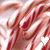 A static image of red and white striped candy canes with a small white heart shape in the center.