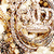 A pixelated animated icon shows a smiling face with closed eyes and visible teeth, wearing layered necklaces against a textured background.
