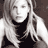 Static grayscale buddy icon of a person with long hair wearing dark clothing, rendered in low-resolution pixel art style on a transparent background.