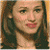 Pixelated close-up of a person with long dark hair, light skin, and pink lips, wearing a dark top against a gradient background.