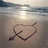 Beach scene with heart and arrow drawn in sand, text overlays reading 'You were never my best friend.' and 'you were always my sister <3'.