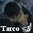 Pixelated static image of a person with dark hair and light skin wearing a dark jacket, overlaid with white text reading 'Taco =3' at the bottom.