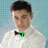 A person in a white shirt and black bow tie appears across four with changing green text overlays