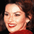 Static 50x50 pixel icon showing a close-up of a person's face with dark hair, red lips, and a red top against a black background.