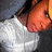 Pixelated image of a person in a white shirt and dark cap on left, orange background with text on right.