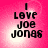 A four- of identical pixelated text reading "I LOVE JOE JONES" on a pink gradient background with white light effects