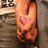 A pixelated image of a person's lower legs and feet with a pink heart on the left foot, transitioning to include text reading 'I love john <33' over the same background.