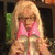 A pixelated image of a blonde woman in pink clothing with hands clasped, overlaid by text reading 'oh my god...' and 'shoes!!!' on separate sections.