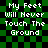 Green and black checkered background with white pixelated text reading 'My Feet Will Never Touch The Ground' in four identical