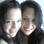 Two people with dark hair in close proximity, one person's face partially obscured by bright light reflection.