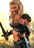 Two figures embrace in a pixelated image with warm-toned background, one figure holding a dark object resembling a microphone.