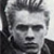 Static grayscale buddy icon of a person with styled hair and dark clothing against a light background, rendered in low-resolution pixel art style.