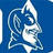 Blue background with white text and a stylized knight head logo, featuring 'Duke is The Best' with a small heart symbol.