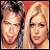 Two pixelated faces side-by-side, one with dark hair and the other with blonde hair against a red background.