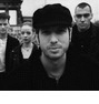 Black-and-white of four showing a person in a flat cap and another with hair tied up, each displaying different cropping or zoom levels