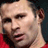 Static 48x48 pixel icon showing a close-up of a person's face with visible facial features and red clothing, rendered in low-resolution pixel art style.