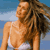 Pixelated static image of a woman in white bikini top against blue sky background with visible dithering and low-resolution rendering artifacts.