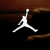 White silhouette of a jumping figure on dark background, black Nike swoosh logo with 'NIKE' text, red 'JUST DO IT!' text blocks below.