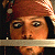 A pixelated contact sheet showing two frames of an animated icon featuring a character with brown hair and a bandana, alongside green text reading "Original Icons .com" on a dark background.