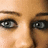 A pixelated close-up of a person's eyes on a bright pink background with text reading 'These eyes will break your heart.'