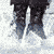 A pixelated image of a woman with dark hair in a ponytail wearing a white top, holding a silver handgun against a blue background.