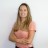 Pixelated static image of a person with long brown hair wearing a light pink top against a light background.
