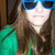 four identical images of a person in a green shirt and blue sunglasses, with a pixelated green cartoon character and text on the right