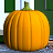 Four identical orange pumpkins with green stems sit on a gray surface against a background of green and white