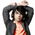 A person with dark hair and a black jacket over an orange shirt holds both hands above their head in a pixelated image.