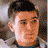 Static pixelated image of a person's face with short dark hair and light skin tone, rendered in low-resolution 256x256 pixels with visible dithering and color blending.