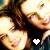 Pixelated image of two figures in close physical proximity with a white heart symbol overlaid on the lower right.