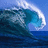 A pixelated ocean wave with white foam cresting against a blue sky background, rendered in varying shades of blue and white.