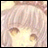 A pixelated anime-style character face with light pink hair and brown eyes on the left, next to stylized text reading "Anime IM" above a smaller "com" on a black background.