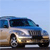 Pixelated image of a light-colored vehicle with blue accents against a pale blue sky background.