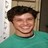 Static 48x48 pixel icon showing a smiling person with dark hair wearing a teal shirt against a light background.