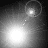 Four grayscale show a bright circular light source moving across the frame with faint dotted trails, forming an arc pattern