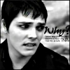 Black-and-white close-up of a person with short dark hair, wearing a dark collared shirt, against a blurred background with text reading 'Why?'