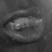A grayscale abstract shape with smooth gradients and soft edges on a dark background, appearing as an indistinct rounded form.