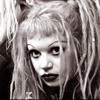 Black-and-white static image of a person with long wavy hair and bangs, featuring high-contrast shading and visible pixelation typical of early digital art.