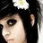 Pixelated close-up of a person with dark hair and a white flower with yellow center on their head, against a dark background.