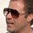 six pixelated images showing a person wearing dark aviator sunglasses with mouth open, accompanied by repeated text "rocking in my aviators" below