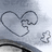 A static image shows a light gray background with two heart outlines and a small cross-like shape, accompanied by the text 'llamas', 'complete', and 'me' in white pixelated font on black sections.