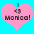 Two identical pink heart-shaped icons with black text and symbols on a bright blue background, each displaying 'I <3 Monica!' in pixelated font.
