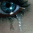 A pixelated close-up of a human eye with tears, paired with cyan text on blue background reading 'I know my eyes look pretty when I cry but i dont so dont make me cry from a BROKEN HEART'.