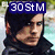 Pixelated anime-style character with dark hair and black clothing, overlaid with blue text blocks containing phrases like "30 St M" and "stop global warming."