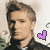 A pixelated image of a person with light brown hair in a dark jacket, featuring a purple heart symbol on the right side.